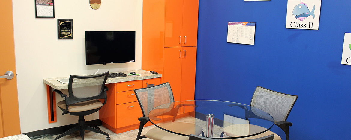 The image shows two distinct office spaces with contrasting color schemes: one half in blue and orange hues, and the other in white and red.